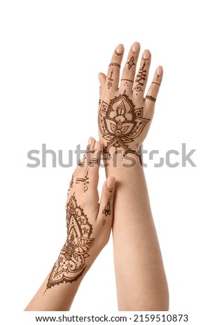 Female hands with beautiful henna tattoo on white background