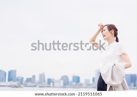 Sweating businesswoman on a sales trip Royalty-Free Stock Photo #2159511065