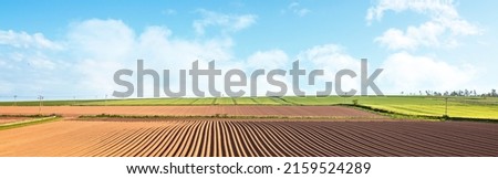 Arable land ploughed field background panorama ready for crops in springtime summer