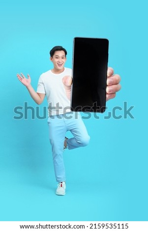 Asian handsome and cheerful young man using smart phone, isolated on background