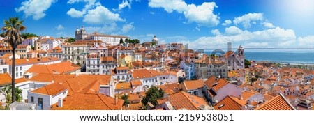 Panoramic view of the beautiful skyline of Lisbon, Portugal, with red roofed, colorful houses in the Alfama district during a sunny day Royalty-Free Stock Photo #2159538051