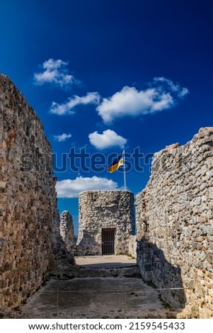 The small village of Tolfa, in Lazio. Remains of the ancient walls of the fortress on top of the cliff. Ruins of the castle. The tower where the flag of Ukraine is hoisted as a sign of solidarity.