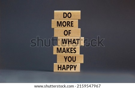 Do what makes you happy symbol. Wooden blocks with words 'Do more of what makes you happy'. Beautiful grey background, copy space. Business, do what makes you happy concept.