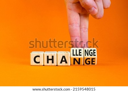 Chance or challenge symbol. Businessman turns wooden cubes and changes the concept word challenge to chance. Beautiful orange table orange background. Business challenge or chance concept. Copy space.