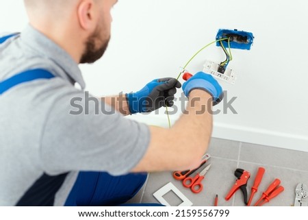 Professional electrician working on the electrical system, home improvement and repair concept Royalty-Free Stock Photo #2159556799