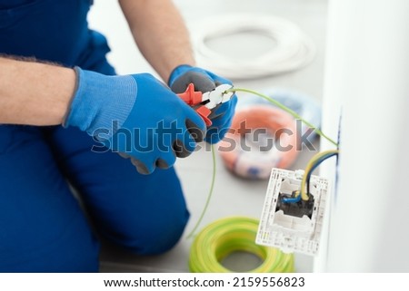 Professional electrician working on the electrical system, home improvement and repair concept Royalty-Free Stock Photo #2159556823