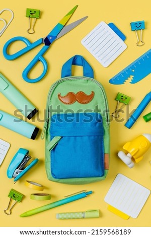 School stationery on yellow background. Pencil case with stationery supplies. Concept back to school. Workplace organization