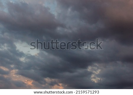 Summer cloudy dramatic rainy sky background. Panoramic view with beautiful clouds. Horizontal cloudscape. High-resolution photography. Design element. Selective focus. Copy space. 