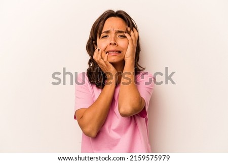 Young hispanic woman isolated on white background whining and crying disconsolately.