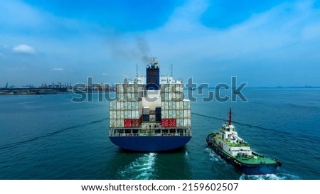 Container ship was dragged by tug boat to international cargo port for service transportation  ,logistic service transportation and maintenance concept