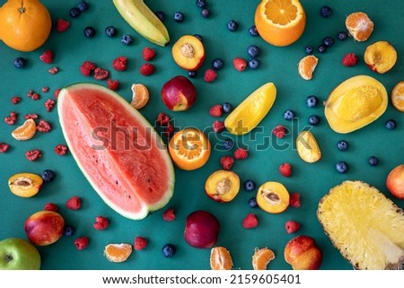 Tropical fruits on a blue background, flat lay.