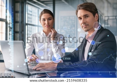 Businessman and businesswoman in formal wear working together to optimize trading strategy at corporate finance fund. Forex chart hologram over office background with panoramic windows
