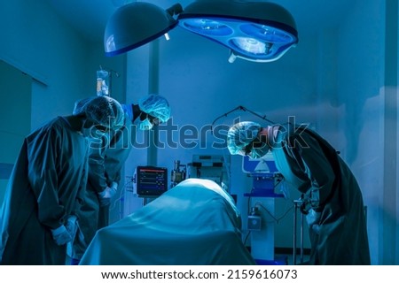 Team of surgeon doctors are paying respect and tribute to the organ donor transplant after his death from incurable disease to save more life in emergency surgical room Royalty-Free Stock Photo #2159616073