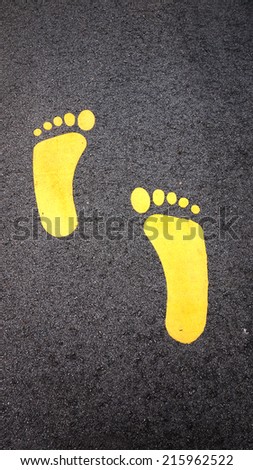 Painted signs on asphalt for pedestrian
