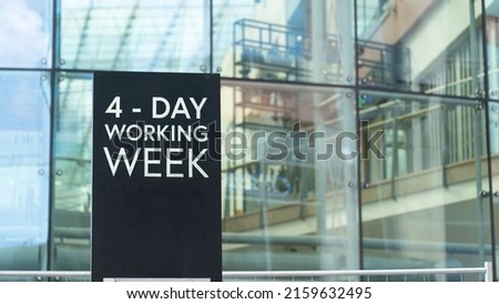 4 - Day working week on a city-center sign in front of a modern office building Royalty-Free Stock Photo #2159632495