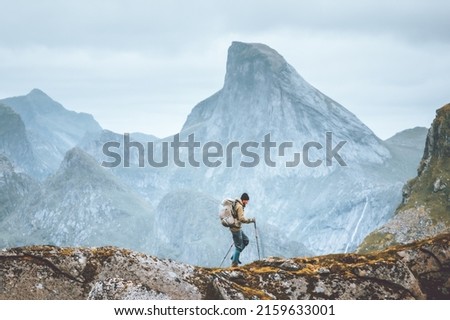 Man hiking in mountains traveling solo with backpack outdoor active vacations in Norway healthy lifestyle extreme sports Royalty-Free Stock Photo #2159633001