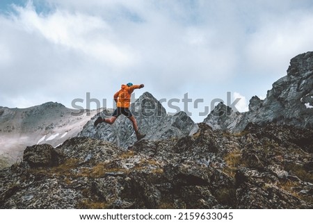 Man trail running in rocky mountains travel hiking adventure activity outdoor summer vacations healthy lifestyle skyrunning extreme sport concept Royalty-Free Stock Photo #2159633045