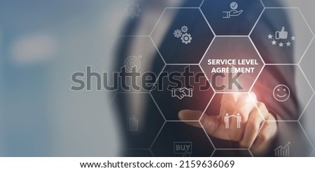 Service Level Agreement (SLA), business concept. Service performance tracking to reduce the uncertainty the customer in process. Businessman touching on SLA with smart screen background. Royalty-Free Stock Photo #2159636069