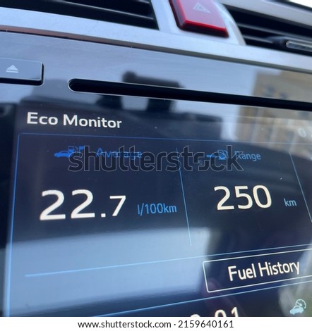 Car infotainment display shows fuel consumption Royalty-Free Stock Photo #2159640161