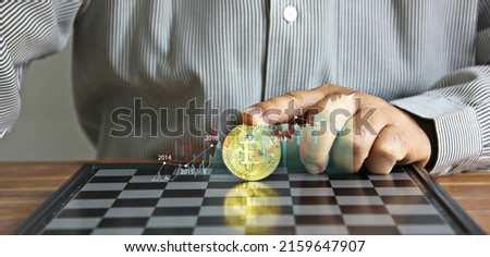 business hand put on index finger on bit coin on chess board with info graphic bit coin trend , bit coin idea concept