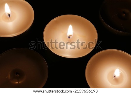 Four candles in the dark.