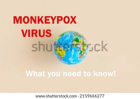 Phrase MONKEYPOX VIRUS what you need to know written on paper with Earth globe. Beige pastel background. Top view, flat lay, copy space. Planet Earth model. World Medical and health concept