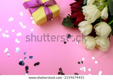  tulips  and gift box on pink background. Stylish soft image of spring flowers. Happy womens day. Happy Mothers day
