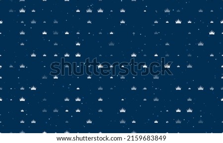 Seamless background pattern of evenly spaced white crown symbols of different sizes and opacity. Vector illustration on dark blue background with stars