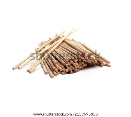 Several pieces of rattan sticks are placed on a white background. Royalty-Free Stock Photo #2159695853