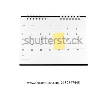 single blank yellow sticky note attached on white cardboard desk calendar with days and dates isolated on white background, monthly business deadline planning or event reminder scheduled Royalty-Free Stock Photo #2159697445