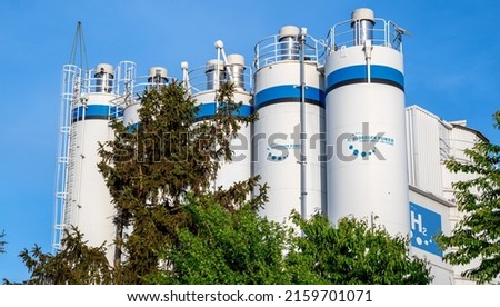 Hydrogen renewable energy production - hydrogen gas for clean electricity solar and windturbine facility.  Royalty-Free Stock Photo #2159701071