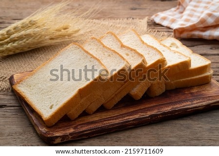 Sliced white bread on wooden board Royalty-Free Stock Photo #2159711609