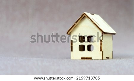 Put the wooden model of the house on the fabric. the concept of real estate investment. planning to save money in coins for the purchase of a house concept for real estate,