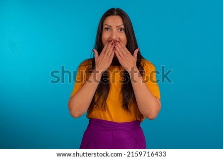 Young woman in studio photo and in colorful clothes.