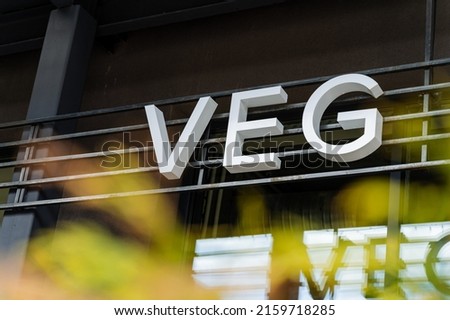 The word vegan, the sign of a vegetarian institution, yoga cafes on the street, advertising a healthy lifestyle, oriental themes, the word veg. High quality photo