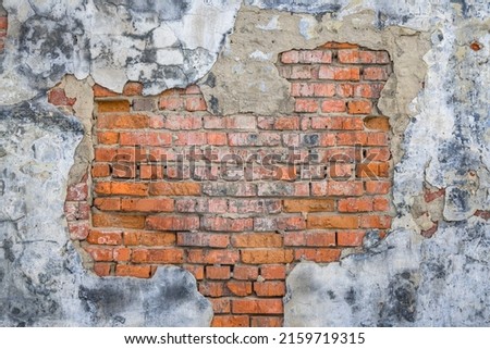 Grunge background, old red brick and plaster wall texture, abandoned exterior urban background.