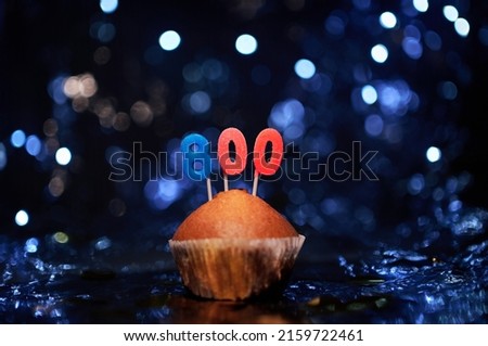 Digital gift card birthday concept. Tasty homemade vanilla anniversary cupcake with number 800 eight hundred on aluminium foil and blurred bright background in minimalistic style. High quality image