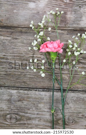 Bouquet of carnations on an old wooden surface