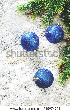 Christmas decorations on a light wood background. tinting. selective focus on the bottom ball