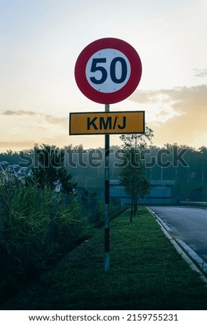 The picture shows a sign board 50 km per hour