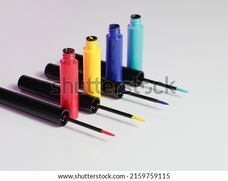 Four colored eyeliners photography in shallow focus in white background