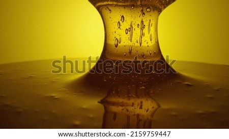 Honey dripping, pouring from spoon. Thick viscous honey molasses dripping. Close up of golden honey liquid, sweet product of beekeeping. Sugar syrup is pouring. Healthy and curative dessert. Royalty-Free Stock Photo #2159759447