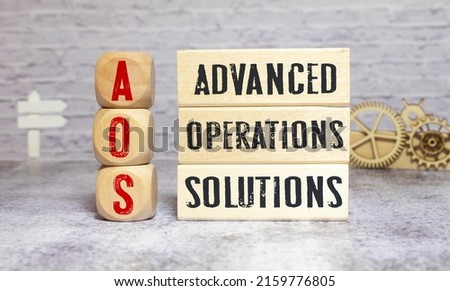 text Advanced Operations Solutions - AOS on wooden block