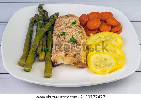 baked haddock served with asparagus carrots and summer squash, Royalty-Free Stock Photo #2159777477