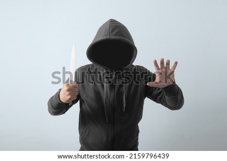 front view faceless man holding knife Royalty-Free Stock Photo #2159796439