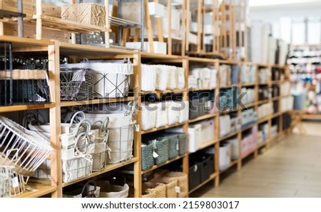 Variety of decorative storage boxes displayed on shelving in household goods store. Concept of goods to organize home space Royalty-Free Stock Photo #2159803017