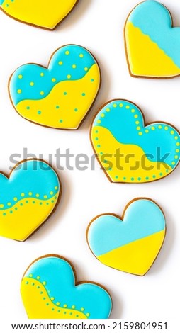 Heart shape ukrainian colours blue and yellow national flag gingerbread candies on white background.