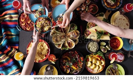 An authentic Mexican family celebrates Cinco de mayo together at a festive table. Mexican food. Royalty-Free Stock Photo #2159819653