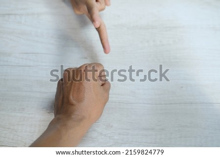 The hand gestures of the Asian man and woman are isolated over white background