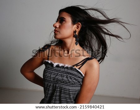 female poses indoor studio with make up 
